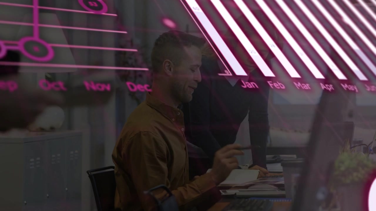 Seated man pointing to doc, team reviewing, magenta bar and pie charts expanding over business desk