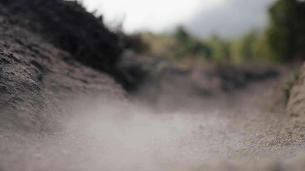Volcanic ash dust blowing across Acatenango hiking trail in Guatemala
