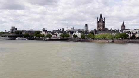 pan of the city of cologne from between the two bridges on the rhine river