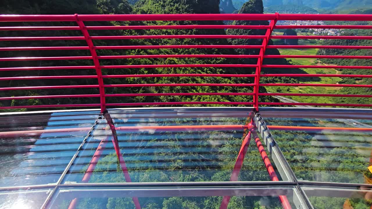 Tilt shot on a glass bridge at the Ruyi Peak Ropeway, summer in Yangshuo, China