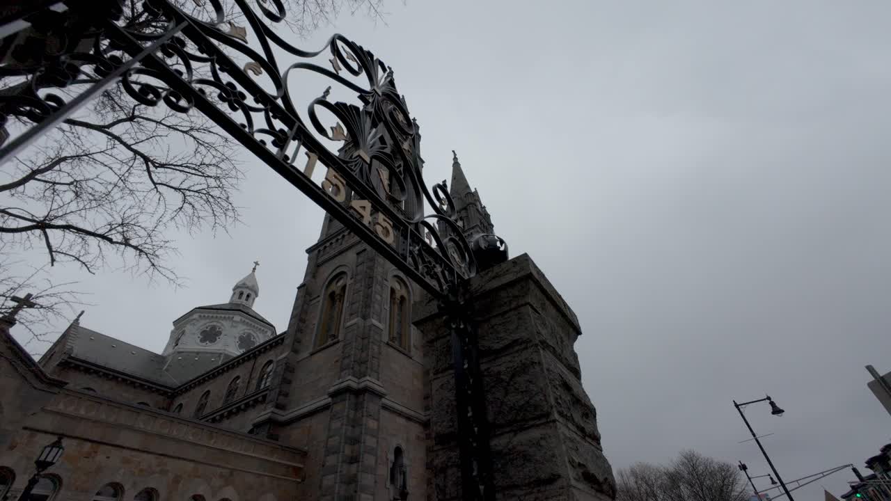 Exterior Facade And Bell Towers Of Basilica of Our Lady Of Perpetual Help Against Cloudy Sky. Boston, Massachusetts. low angle, revealing shot
