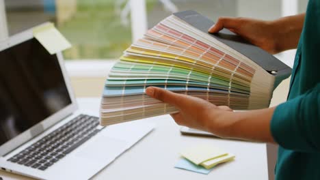 female graphic designer holding color shade cards 4k