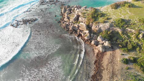 Waves-break-on-the-rocks-and-sands-of-the-beach-at-Kish-Island,-Iran