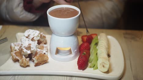 chocolate fondue with waffles and fruit