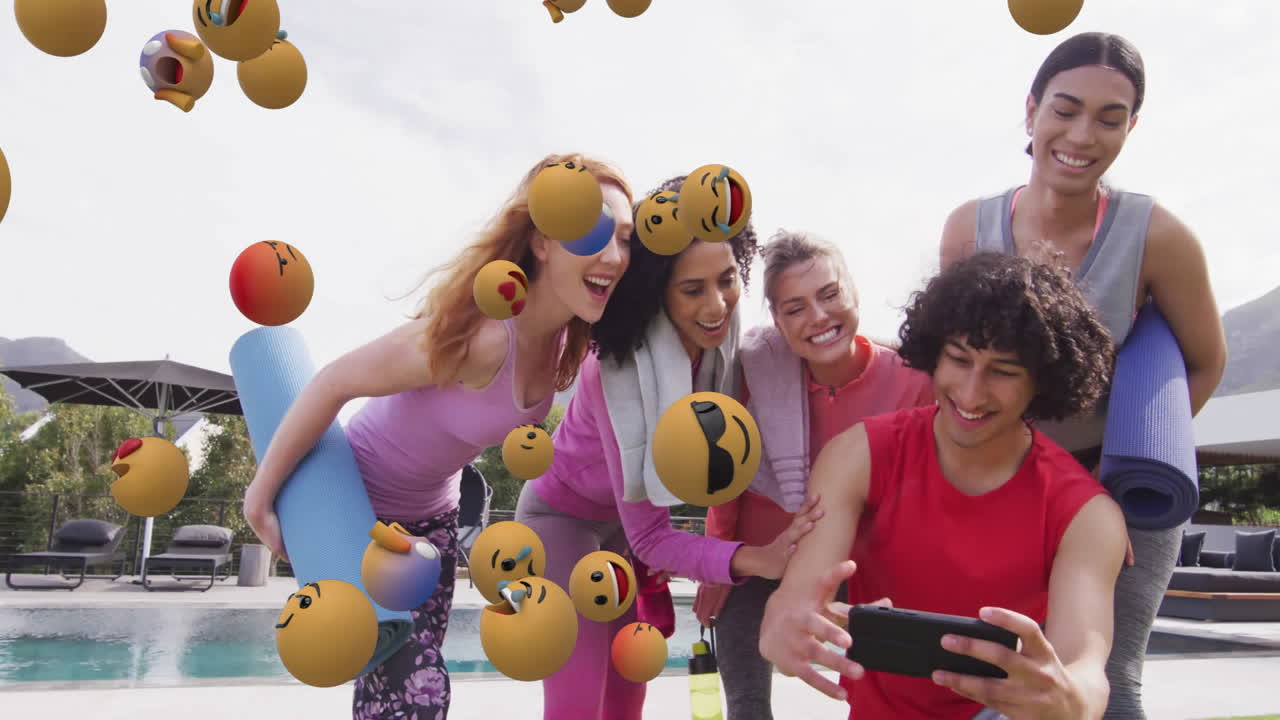 Group of friends laughing and looking at smartphone over emoji animation