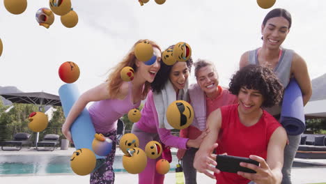 group of friends laughing and looking at smartphone over emoji animation