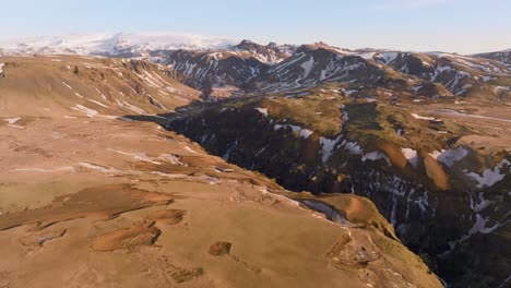 scenic iceland mountain panorama with snow capped peaks in sunrise, aerial view