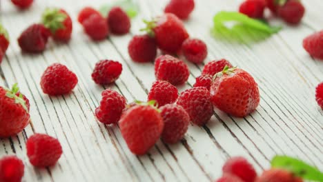 raspberries and strawberries on table