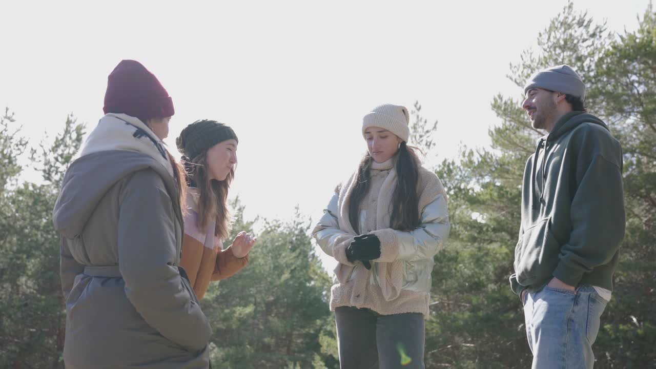 A group of friends talking outdoors in winter