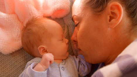 Mother-sleeping-with-her-baby-boy-at-home-4k