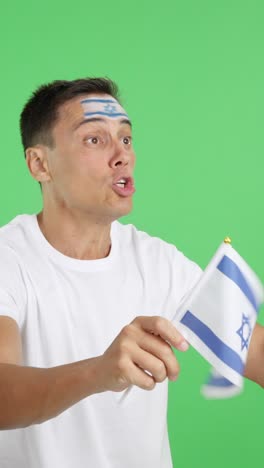 Man cheering for Israel waving a national flag looking away