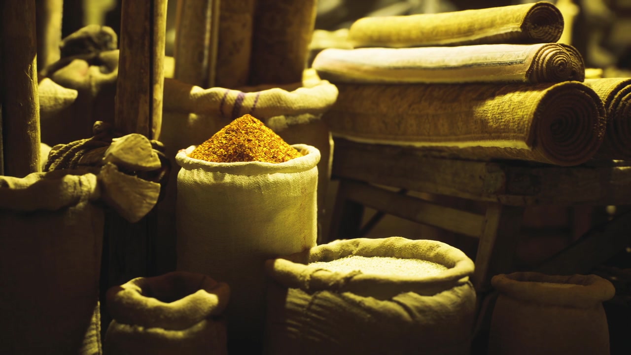 Burlap bags containing fragrant spices and grains prepared for bulk showcase
