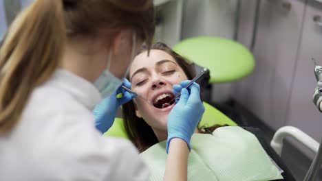 Oral-hygiene-and-dental-care:-Doctor-dentist-working-with-patient-in-dental-clinic.-Healthcare-concept.