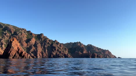 Incredible-Scandola-natural-rock-formations-seen-from-boat-in-Corsica,-France