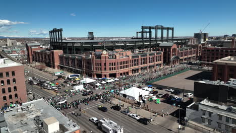 Aerial-view-of-the-Saint-Patrick's-Day-parade-marching-through-Denver,-Colorado's-downtown-district