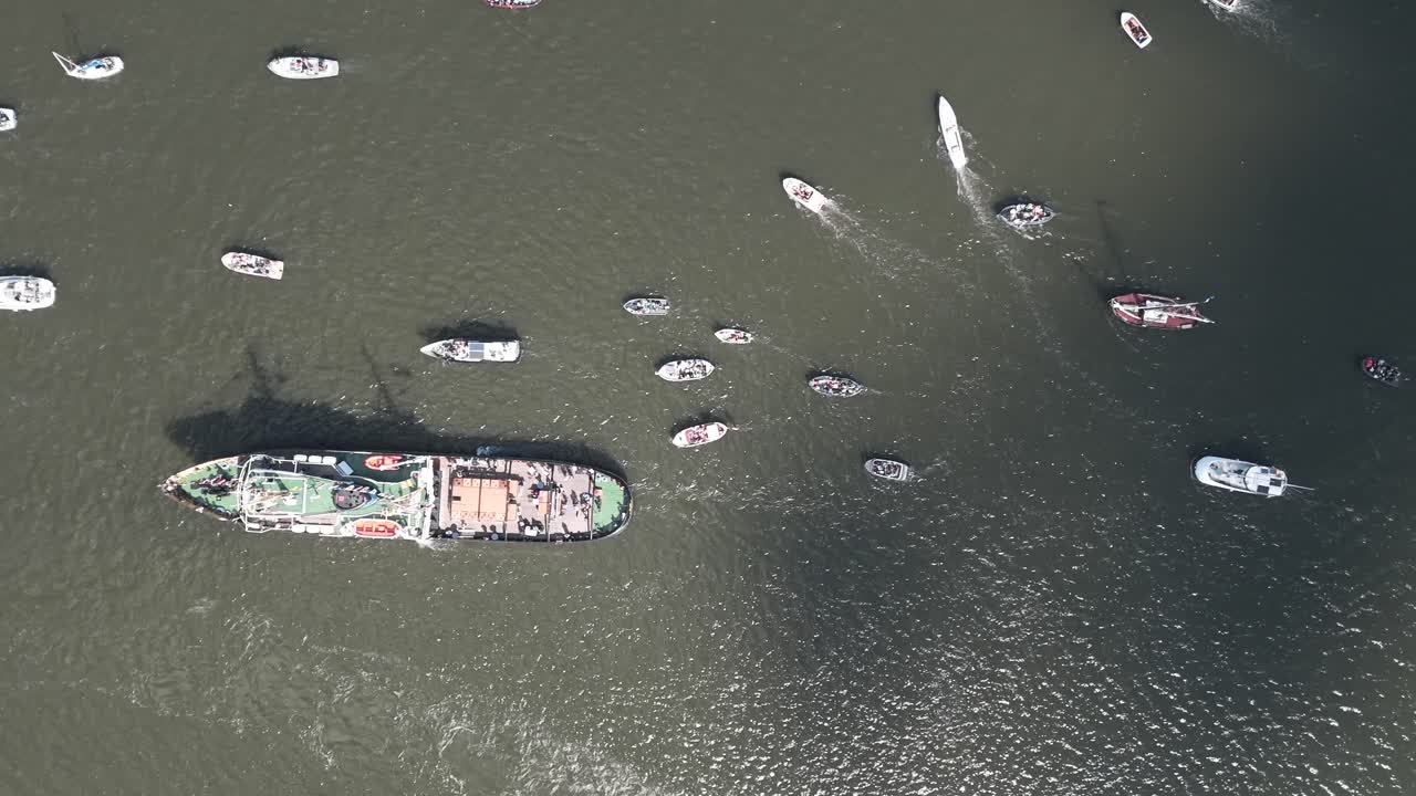 Birdseye aerial top shot of moving sailboats during Amsterdam Sail harbor festival, backdrop texture