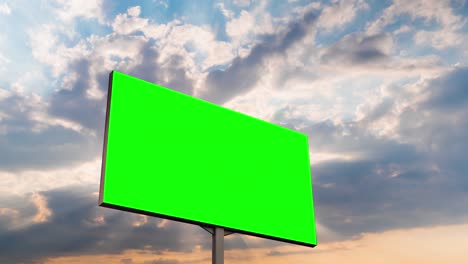 timelapse - blank green billboard and moving white clouds against sunset sky