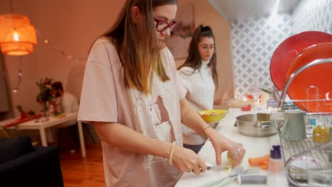 two women cooking together in a kitchen