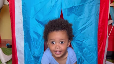 adorable niño afroeuropeo de dos años jugando en su tienda de juguetes papá sorprendente