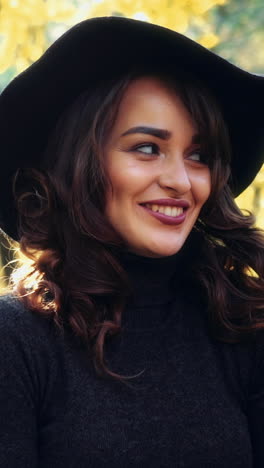 girl walking in park. attractive woman walking in autumn forest vertical video