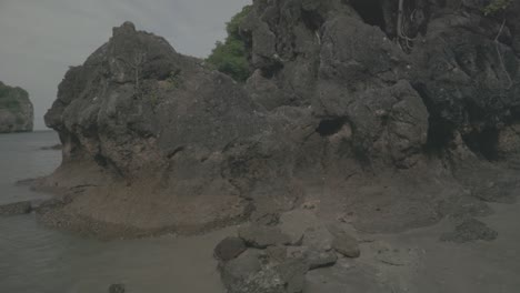 walking towards the rock on the beach in thailand.