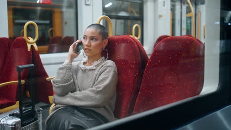 woman talking on phone on train