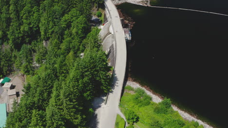 Aerial-flying-over-the-Cleveland-Dam-on-the-Capilano-River-in-North-Vancouver,-British-Columbia