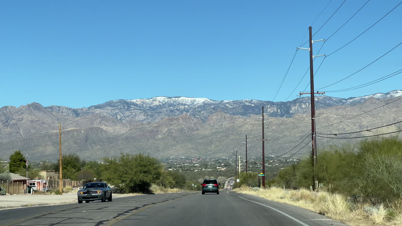 Snow-capped Mount Lemmon in Tucson Arizona, seen from inside driving car