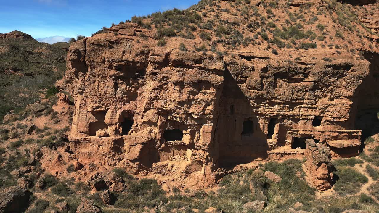 Almagruz troglodyte city. Prehistoric settlement of caves in the mountain. Aerial view. Dolly out. Purullena. Spain.