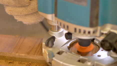 brushless compact router smoothening the edge of a drilled hole