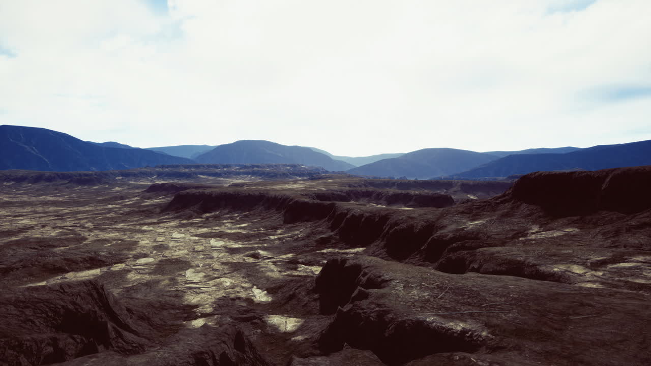 Vast rocky landscape under a cloudy sky in a remote mountain region