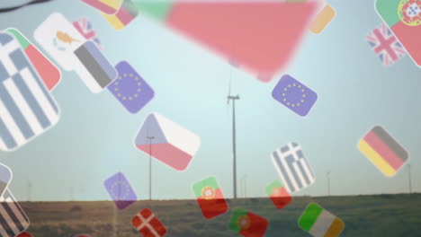 slender wind turbines spinning on grassland field, translucent flag icons drifting across sky