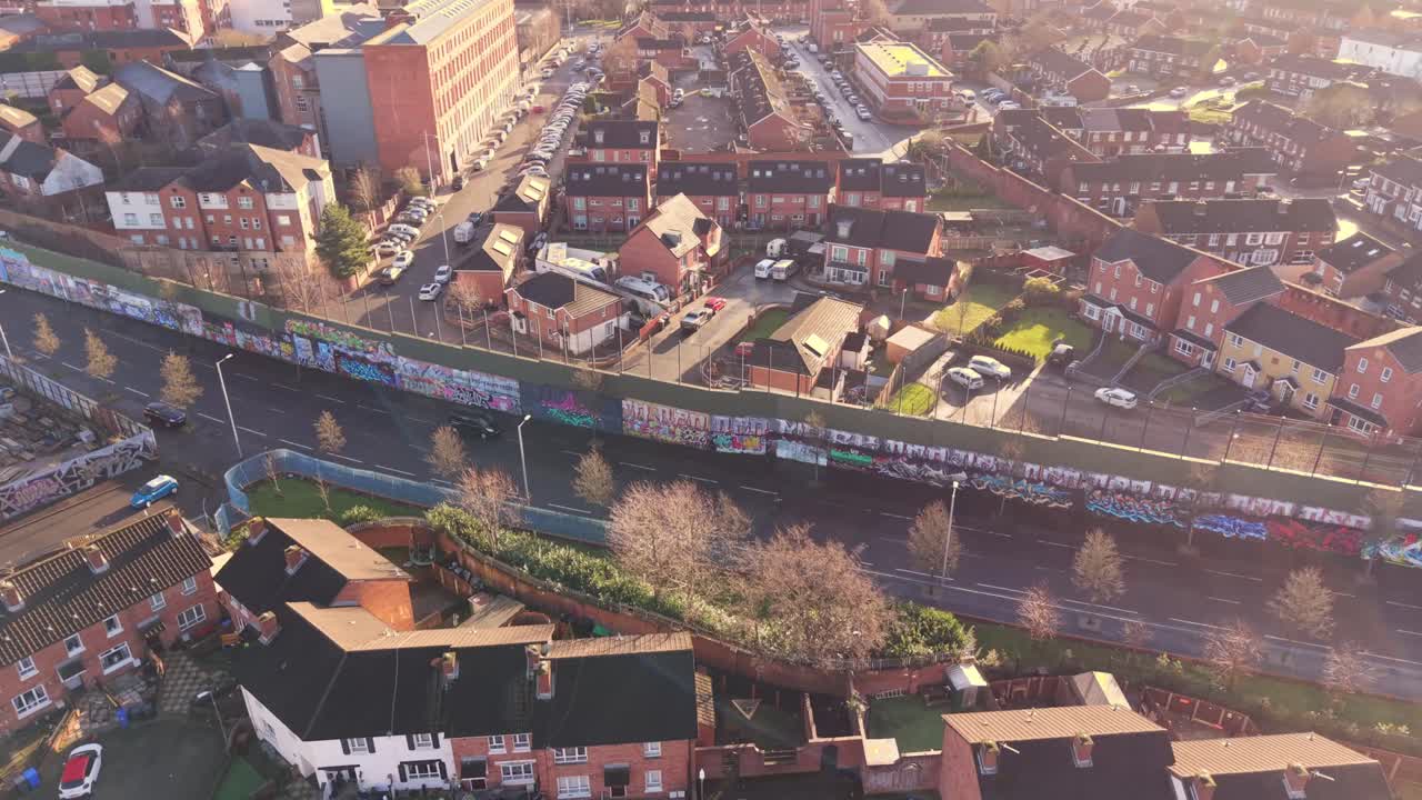 Stigende 4K 60FPS flyvideo av Belfast Peace Wall Interface i Belfast, Nord-Irland. Veggmaleriene utforsker politikken i Nord-Irland og resten av verden. Produsert med Rec709-farger