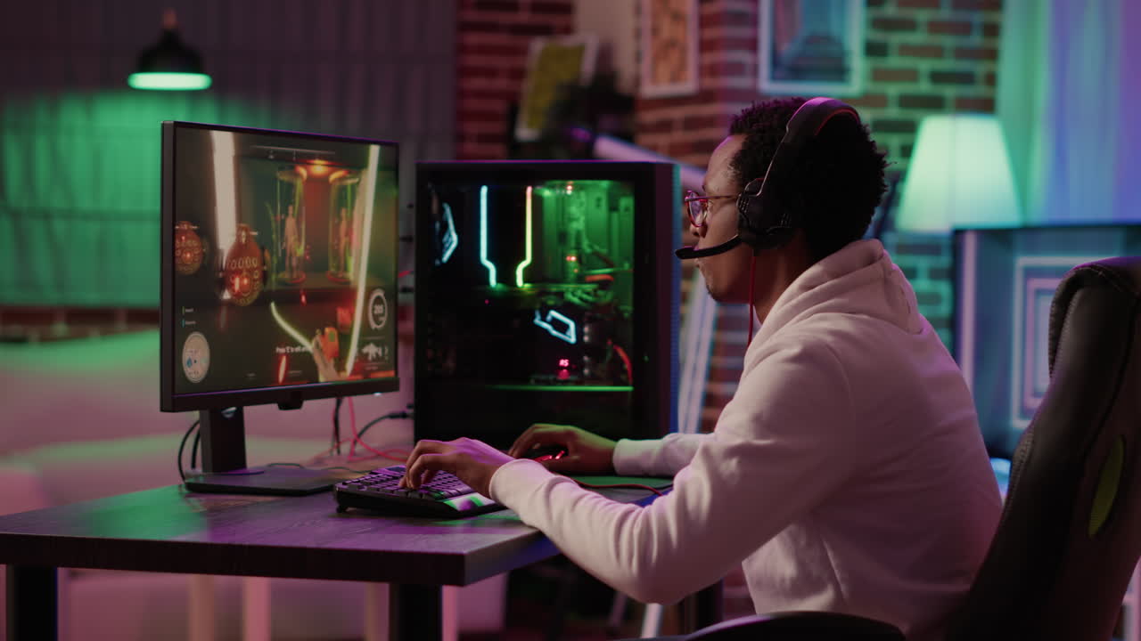 African american gamer relaxing playing online action game using pc gaming setup and talking to team