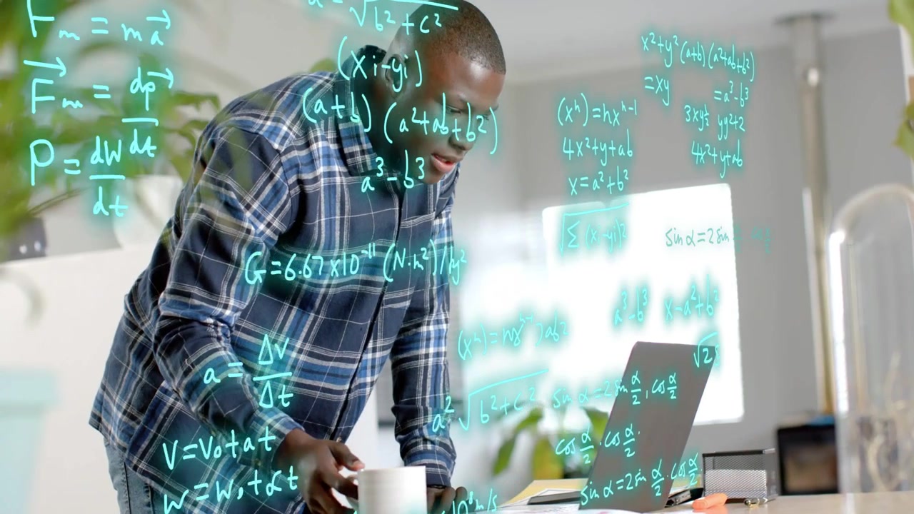 Male engineer typing on laptop and starting equations layering around him while checking results