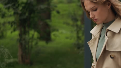 caucasian female student writing in notebook at the park.