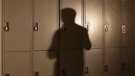 shadow of a person on a row of lockers