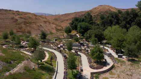 aerial reverse pullback shot of a peaceful nature garden at a california mortuary