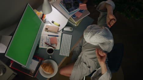 relaxed girl stretching home workplace top view. bathrobe woman making pause