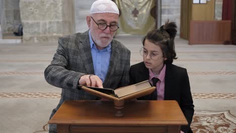 man and child reading quran