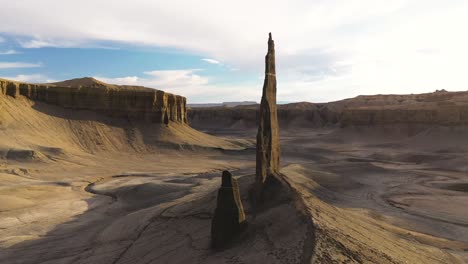 an extremely unique rock pinnacle formation in the utah desert wilderness seen from the air in an epic dolly zoom tracking shot.