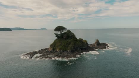 aerial view of an islet in the middle of the sea in guanacaste, costa rica - drone shot