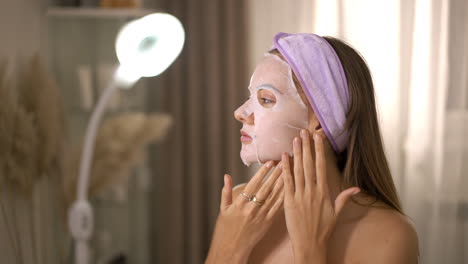 woman applying a sheet mask for a home skincare routine