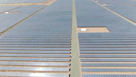 forward moving aerial shot over multiple rows of solar panels in california, usa