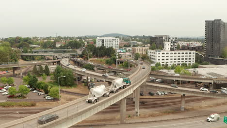 Swooping-aerial-shot-following-cars-and-trucks-on-a-highway-interchange-ramp-USA