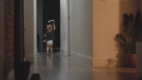 little girl taking boots and running away to try on