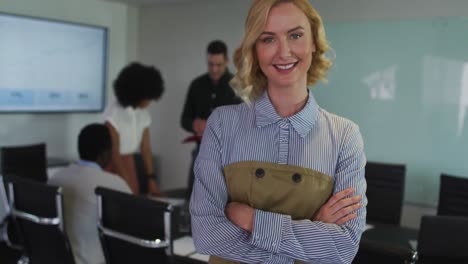 portrait of caucasian businesswoman in meeting room looking to camera smiling