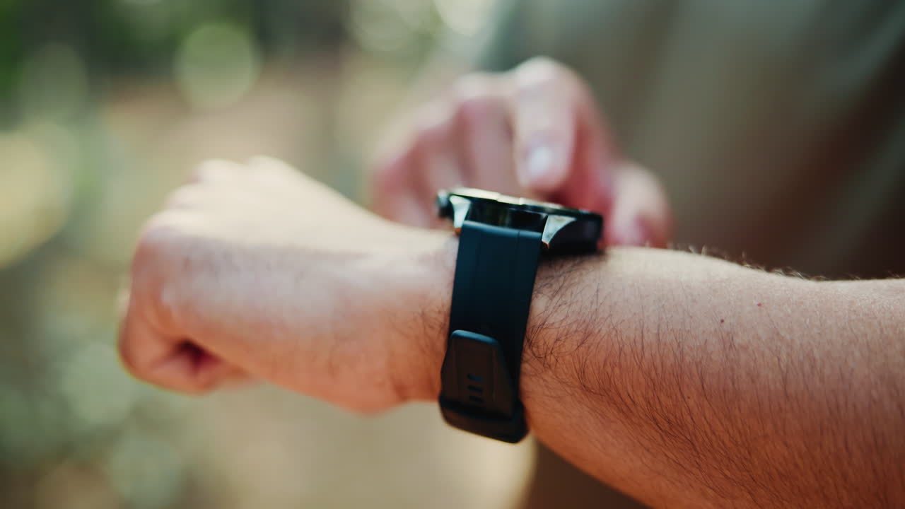 Close-up of Man Tapping Smartwatch Screen Outdoors