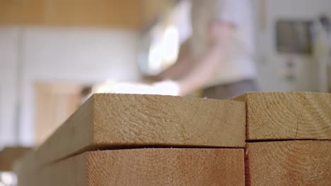 Overtake-Shot-Of-Wooden-Boards-Stocked-In-Workshop