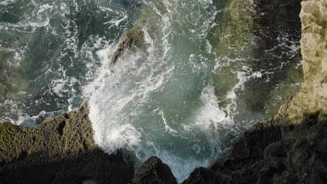 Ocean-waves-crashing-on-rocky-cliff-coast-with-huge-splash-in-slow-motion-view